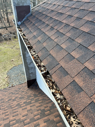 Gutters clogged with leaves and debris before professional cleaning in Stroudsburg PA