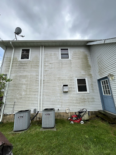 House exterior before pressure washing - stained and weathered siding